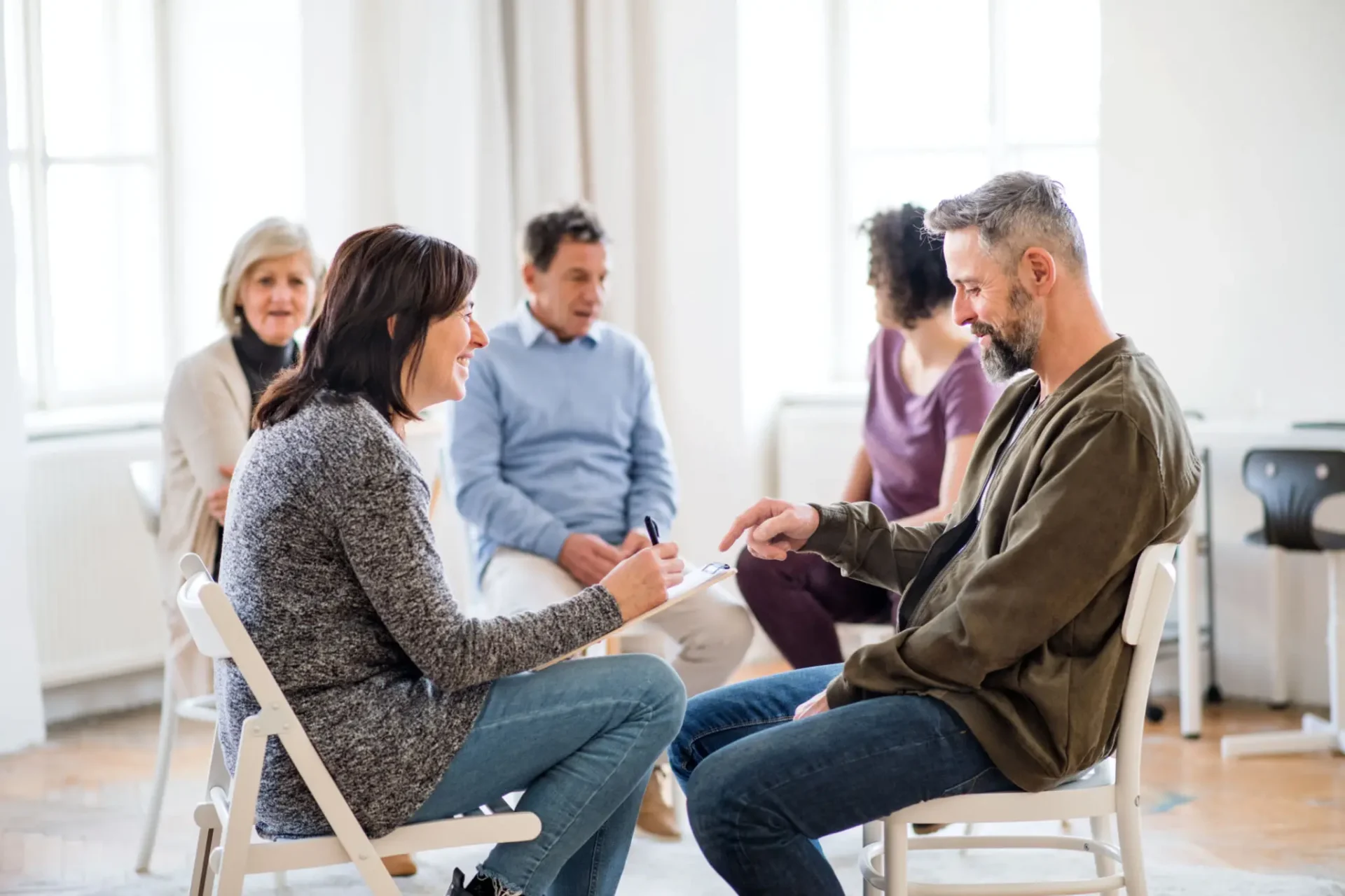 Adults in supportive group therapy circle