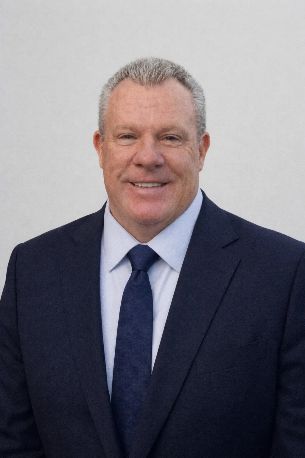 Smiling businessman portrait in navy suit