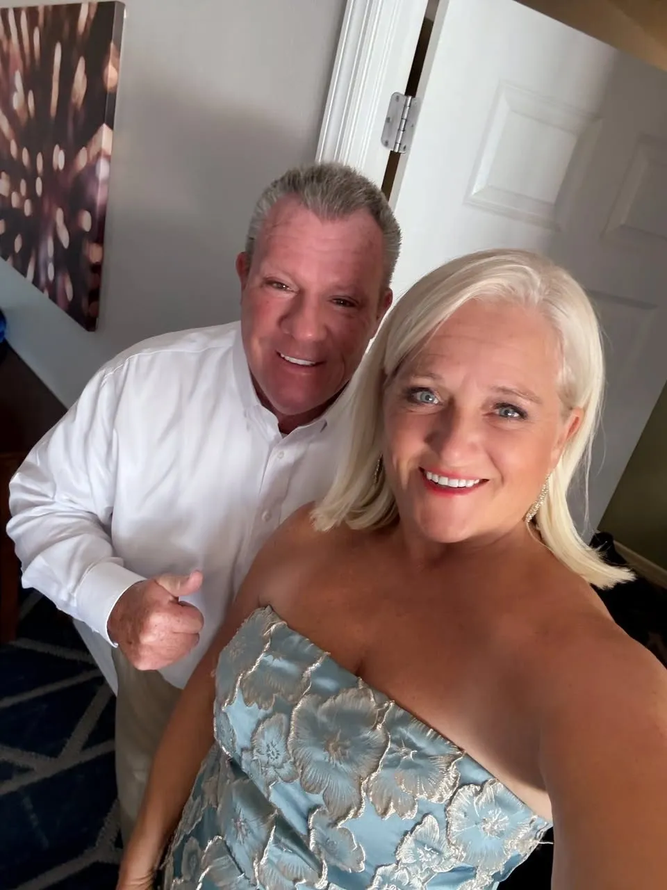 Smiling couple in formal attire posing indoors