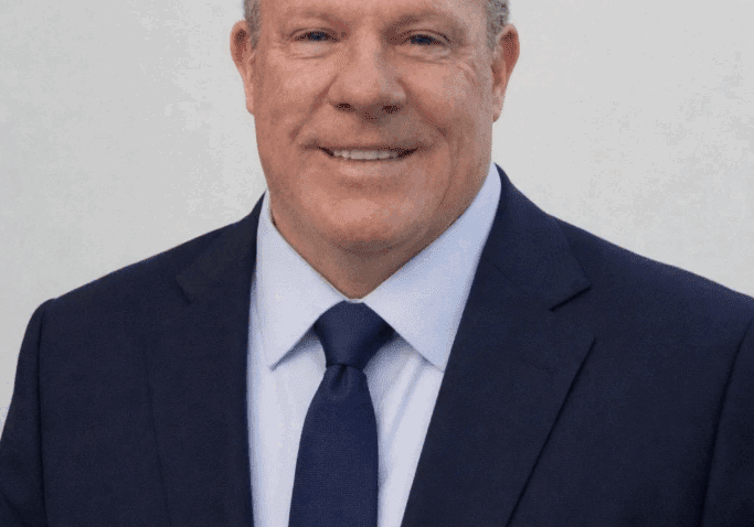 Professional man in a suit smiling confidently.