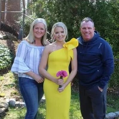 Young woman in yellow gown holding bouquet