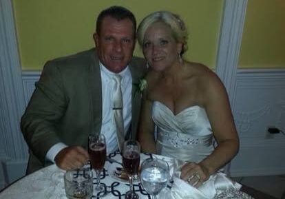 Bride and groom seated at reception table