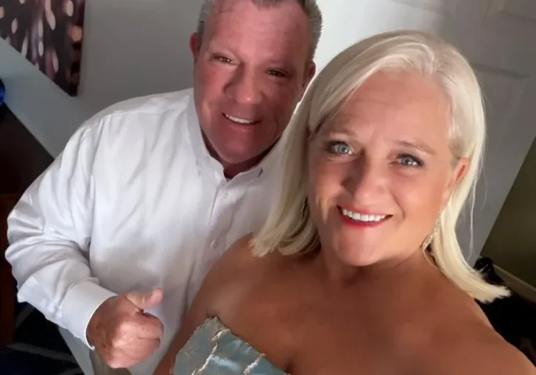 Smiling couple in formal attire posing indoors
