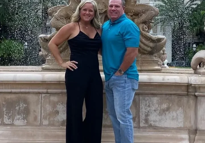 Man and woman posing by ornate fountain