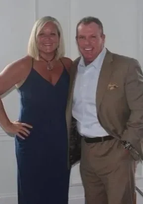 Smiling couple in evening attire at venue