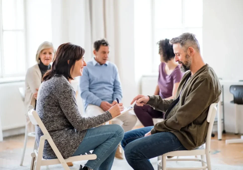 Adults in supportive group therapy circle